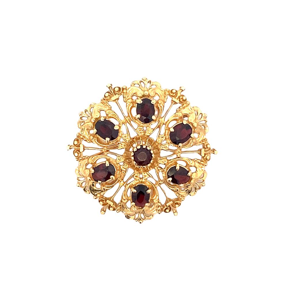 Estate Garnet Filigree Brooch with one (1) 5mm round and six (6) 7x5mm oval garnets, prong-set in a 14KY circular brooch, approx. 43mm, 14.3grams